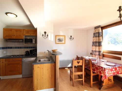 - une cuisine et une salle à manger avec une table et un évier dans l'établissement Appartement spacieux 6 pers avec balcon, internet à Aussois - FR-1-508B-14, à Aussois
