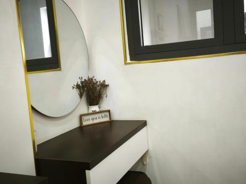 a room with a mirror and a black table at Nguyên căn Homestay -Nhà Mẹ Khang 1 in Cu Chi