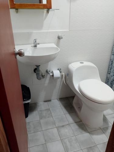 a bathroom with a toilet and a sink at Hotel Boutique Casa Marco in Ciénaga de Oro