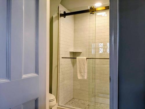 a bathroom with a glass shower with a toilet at Stanton House Inn in Greenwich