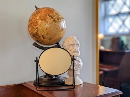 a globe on a table next to a bust at Stanton House Inn in Greenwich