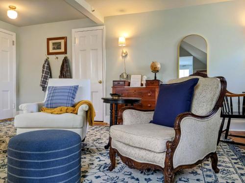 a living room with two chairs and a mirror at Stanton House Inn in Greenwich