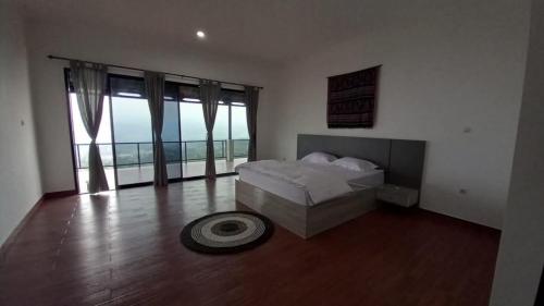 a bedroom with a bed and a large window at Villa lofous in Pasirpogor