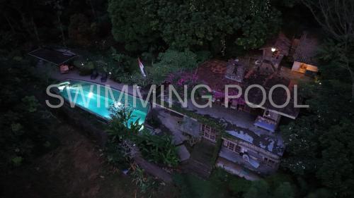 an overhead view of a swimming pool at night at Rumah Lereng Bandung in Bandung