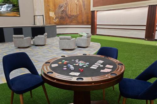 a poker table and chairs in a room with grass at Indy Urban Nest - Sleeps 8 - Skywalk Access - Convention Center in Indianapolis