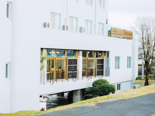 a white building with a balcony at HIKE in Tamana