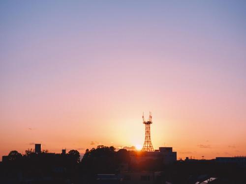 a silhouette of a tower at sunset at HIKE in Tamana