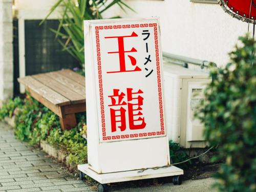 a sign for a restaurant on a sidewalk at HIKE in Tamana