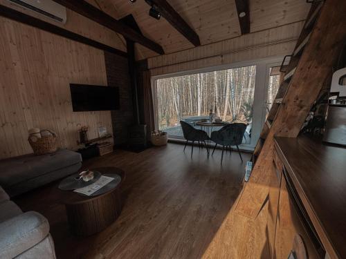a living room with a couch and a table at Bonanza Terra in Rukliai