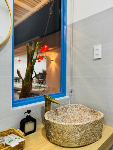 a bathroom with a large stone sink on a counter at MON House 2 in Ấp Sung Xuân