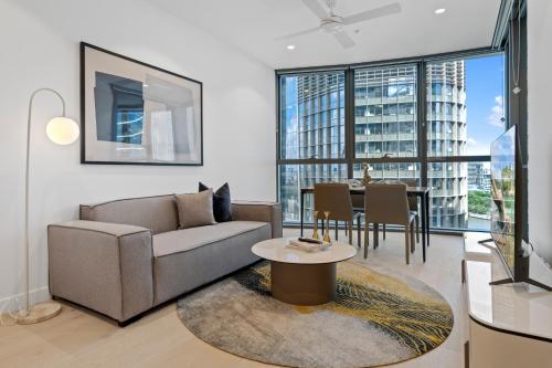 a living room with a couch and a table at CASSA QW - Queens Wharf Modern Apartments Managed by The Cassa in Brisbane