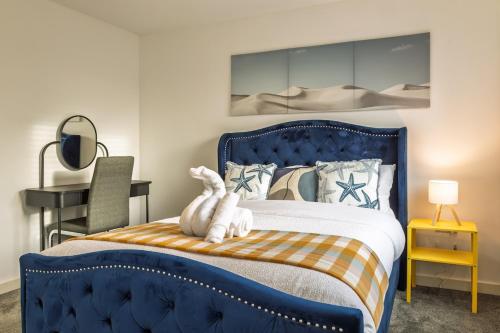 a bedroom with a blue bed with a stuffed animal on it at Affordable House By Amara Apartments Short Term Rental Agency Coventry in Longford
