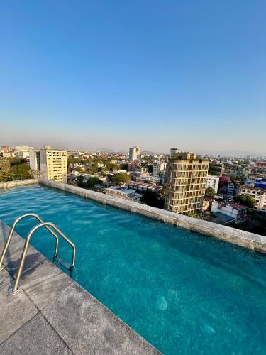 a large swimming pool on top of a building at Roma Norte, pool, gym, rooftop, coworking, balcony & parking in Mexico City