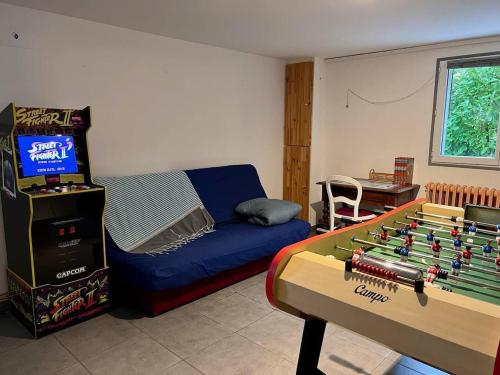 a living room with a foosball table and a couch at Villa clair de Falaises in Le Tréport