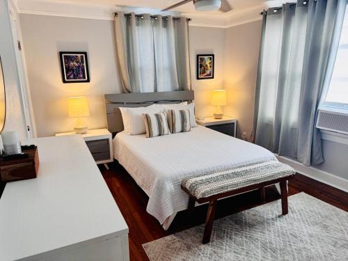 a bedroom with a bed and two lamps and a window at Renovated charming 2BR close to French Quarter in New Orleans