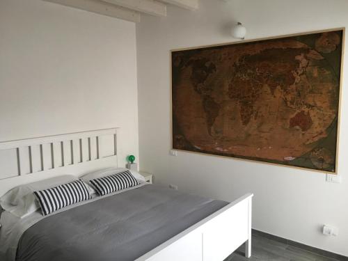 a bedroom with a bed with a map on the wall at B&B Residenza Marina in Marina di Carrara