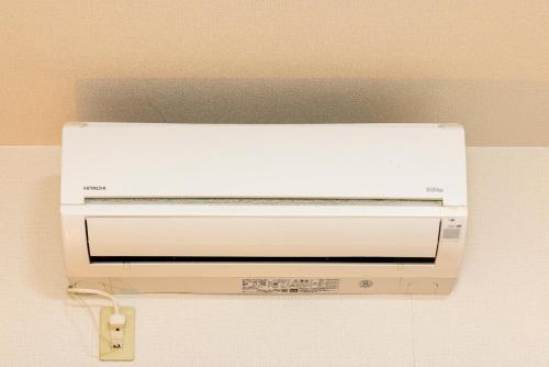 a white toaster oven hanging from a ceiling at Otani gofuku in Fukuoka