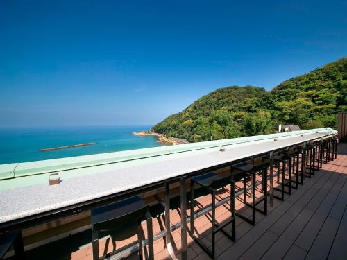 a view of the ocean from a roof at Yuhigauraonsen ShizukaHanaogi in Kyotango