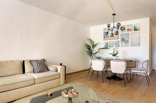 a living room with a couch and a table at Luxurious 2BR Family Apartment - Champel in Geneva