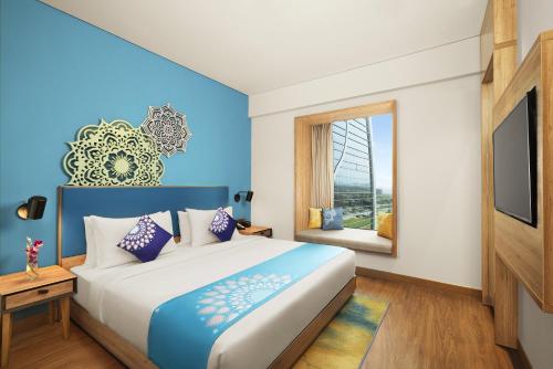 a bedroom with a large bed and a window at Grand Mercure Ahmedabad GIFT City - An Accor Hotels Brand in Gandhinagar
