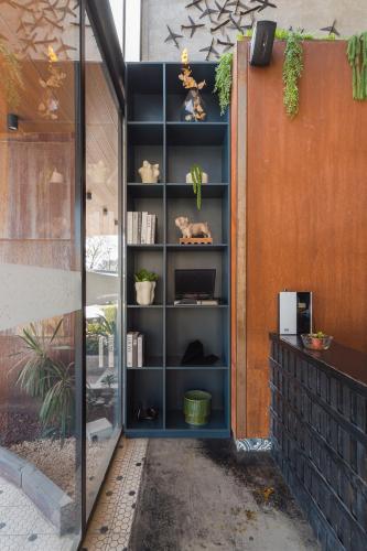 a book shelf with plants on it next to a building at Hangar Select Aeropuerto Guadalajara in Guadalajara