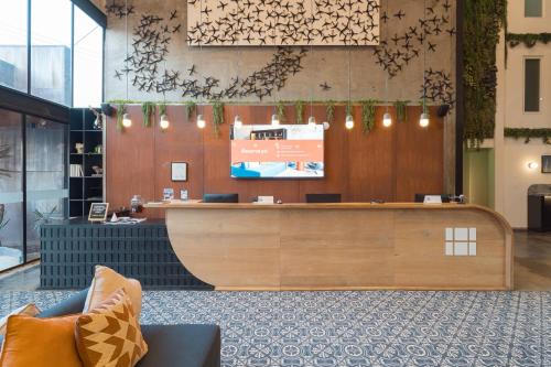 a lobby with a reception desk in a building at Hangar Select Aeropuerto Guadalajara in Guadalajara