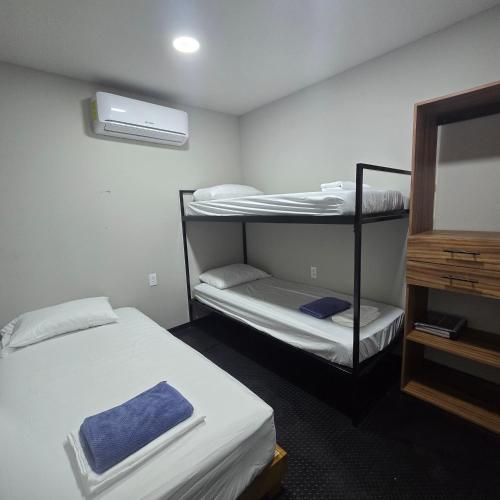 a room with two bunk beds and a fan at Casa en movimiento playabonita in Campeche