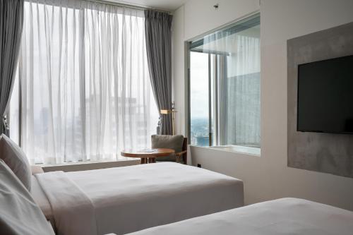 Postel nebo postele na pokoji v ubytování Granbell Hotel Colombo