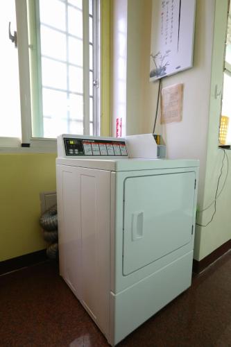 a small white appliance in a room with a window at Mozhu B&B in Hualien City
