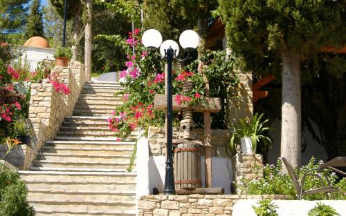 a street light with flowers on a set of stairs at Kerveli Village Hotel in Kerveli