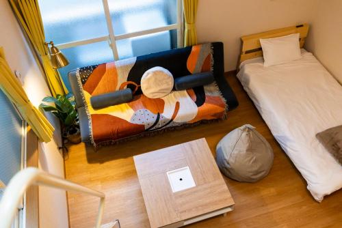 a room with a bed and a table with a blanket at Otani gofuku in Fukuoka