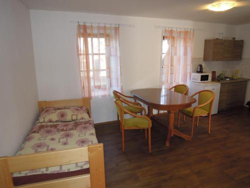 a bedroom with a table and chairs and a bed at Penzion Zámek Drahonice in Drahonice