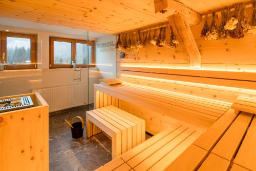 a wooden sauna with a bench in the middle at Der Tannenhof in Reutte