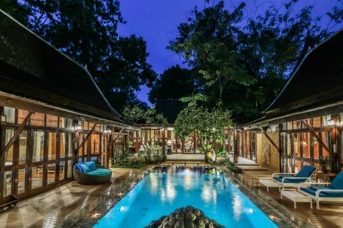 an exterior view of a house with a swimming pool at Luxury Hannah Villas in Chiang Mai