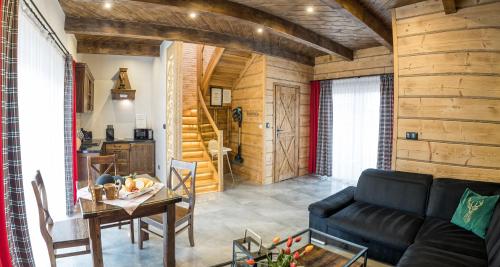 a living room with a couch and a table at Luxury Houses & Apartments Zaliński in Zakopane