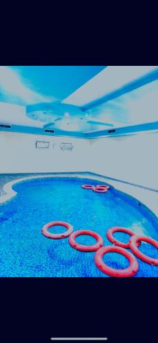 a pair of red scissors sitting on top of water at Comfortable Apartment Bedroom And Spacious Living Room Family and Couple in Sharjah
