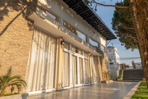 a building with curtains on the side of it at De Lavie Villa DaLat in Khu Chi Lăng