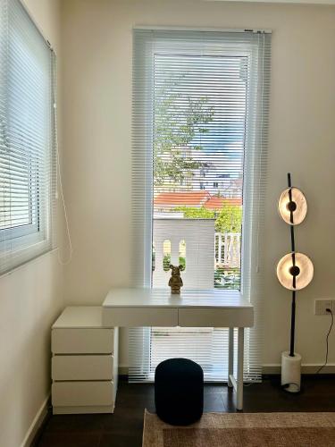 a white desk in front of a window with candles on it at De Lavie Villa DaLat in Khu Chi Lăng