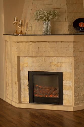 a stone fireplace with a fire place at De Lavie Villa DaLat in Khu Chi Lăng