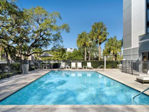 a swimming pool in a building with a building at Hyatt Place Tampa Busch Gardens in Tampa