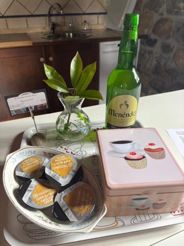 a bottle of champagne next to a plate of cupcakes at La Quintana de Doña Leonor in Arriondas