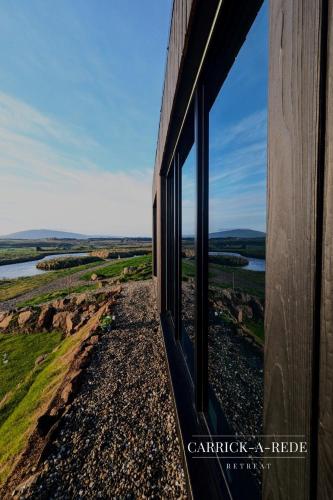 a window of a train looking out at the countryside at Carrick-a-Rede Luxury Retreat Ballintoy Causeway Coast in Ballintoy