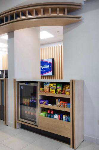a drink cooler in a store with a sign on it at Hampton by Hilton Saltillo Zona Aeropuerto in Saltillo