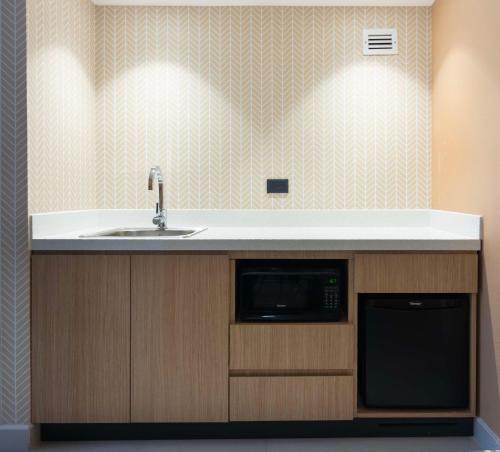 a kitchen with a sink and a microwave at Hampton by Hilton Saltillo Zona Aeropuerto in Saltillo