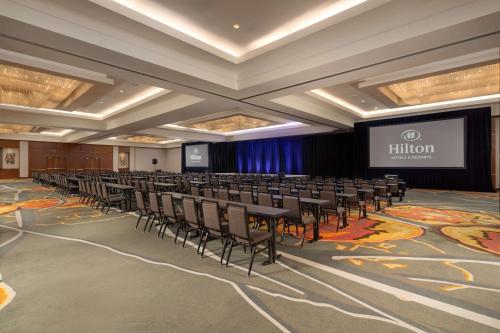 a conference room with rows of chairs and a screen at Hilton La Jolla Torrey Pines in San Diego
