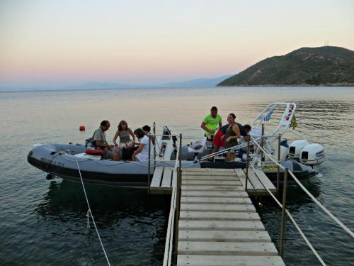a group of people on a boat at a dock at Kerveli Village Hotel in Kerveli