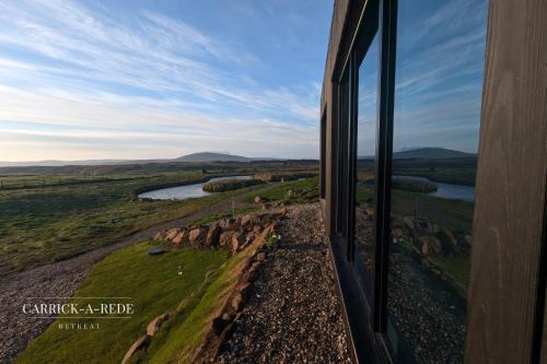 a train traveling through the countryside looking out the window at Carrick-a-Rede Luxury Retreat Ballintoy Causeway Coast in Ballintoy