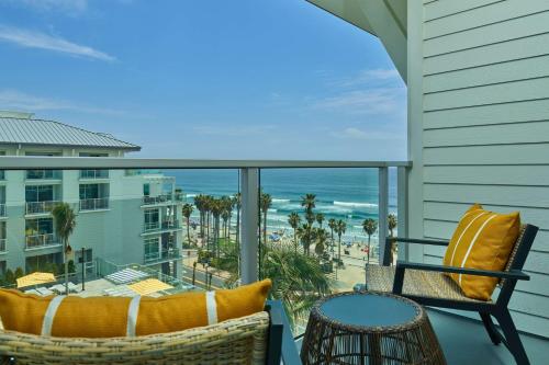 a balcony with chairs and a view of the ocean at The Seabird Ocean Resort & Spa, Part of Destination Hotel by Hyatt in Oceanside