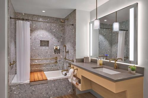 a bathroom with a sink and a shower at Mission Pacific Beach Resort, part of JdV by Hyatt in Oceanside