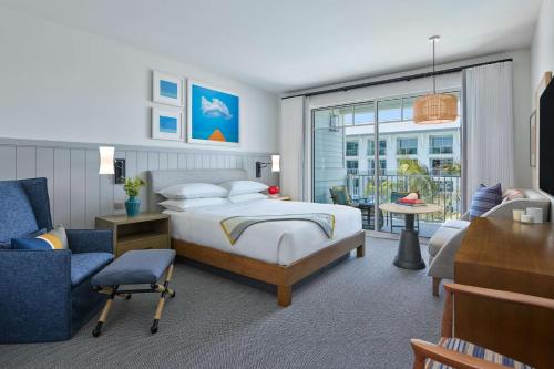 a bedroom with a bed and a living room at The Seabird Ocean Resort & Spa, Part of Destination Hotel by Hyatt in Oceanside